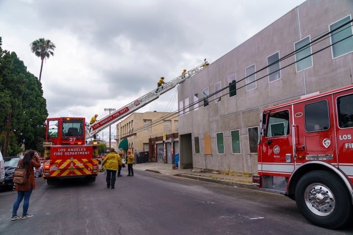 Los Angeles Fire City investigators climb the roof of a Hollywood recording studio.