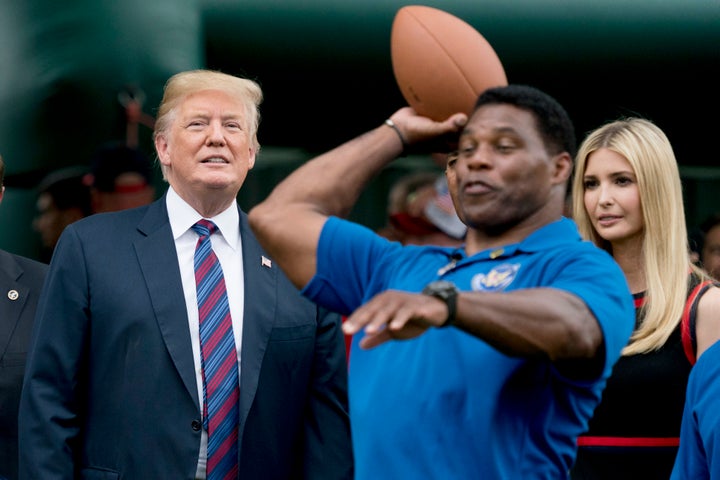 FILE - In this May 29, 2018 file photo, President Donald Trump, left, and his daughter Ivanka Trump, right, watch as former football player Herschel Walker, center, throws football's during White House Sports and Fitness Day on the South Lawn of the White House in Washington. The U.S. Senate nomination in a premier battleground like Georgia should be a plum political prize, but a year before Republican voters choose a nominee for the 2022 midterms, they have no clear options. The wildcard is whether football hero Herschel Walker runs and brings the endorsement of former President Donald Trump. (AP Photo/Andrew Harnik)