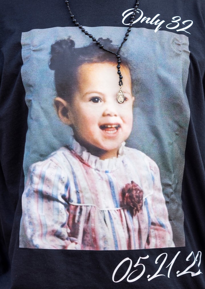 Enrique Owens, a cousin of Roberta Drury, wears a T-shirt with a photograph of her as a little girl before her funeral service, Saturday, May 21, 2022, in Syracuse, New York.