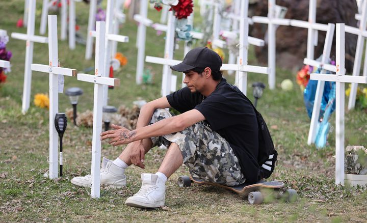 Eric sits on his skateboard as he visits the cross that commemorates his girlfriend Jada, it is one of 243 crosses that cover the lot on the south west corner of Brady and Paris Streets as part of Crosses for Change that memorialize victims in the overdose and opioid crisis in Sudbury. May 9, 2022.
