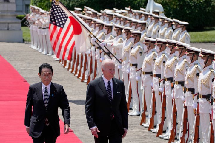 U.S. President Joe Biden, right, and Japan's Prime Minister Fumio Kishida, left, review an honor guard during a welcome ceremony for President Biden, at the Akasaka Palace state guest house in Tokyo, Japan, on May 23, 2022. 