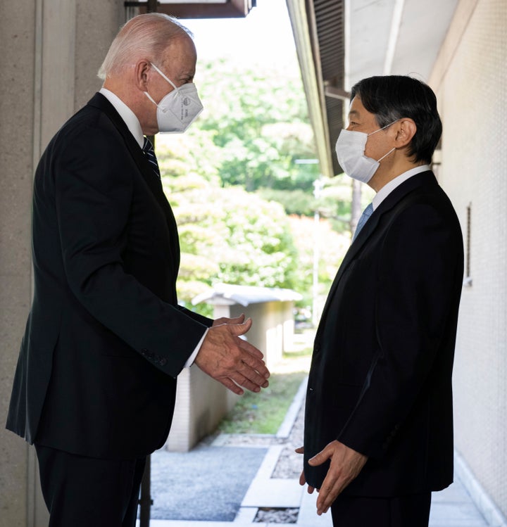 Japan's Emperor Naruhito, right, greets U.S. President Joe Biden prior to their meeting at the Imperial Palace in Tokyo on May 23, 2022. 