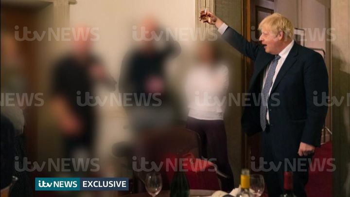 <strong>A photograph obtained by ITV News of the prime minister raising a glass at a leaving party on November 13, 2020, with bottles of alcohol and party food on the table in front of him.</strong>
