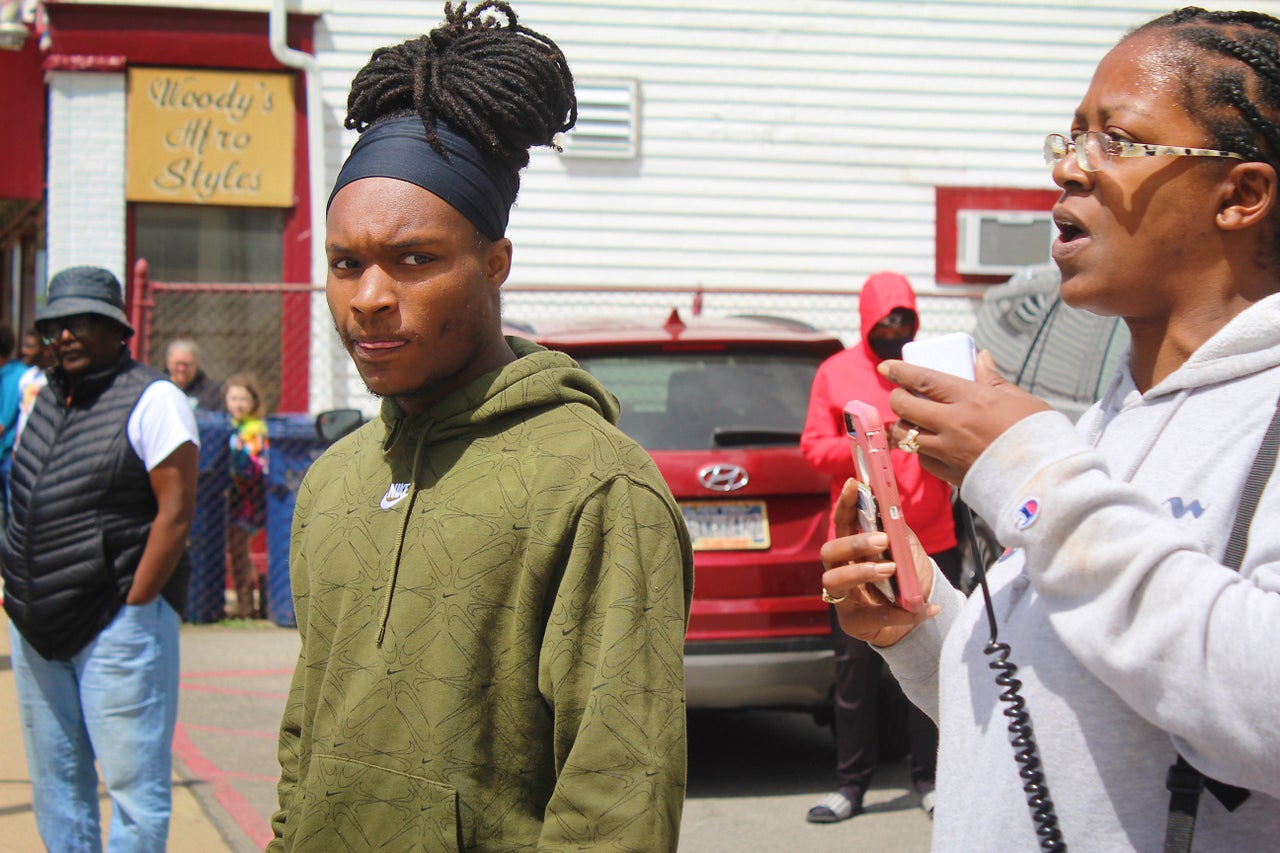 David Louis, a local activist (left), looks on during a rally outside of a neighborhood community center the day President Joe Biden came to give remarks following the Buffalo mass shooting.