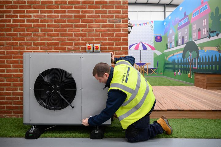 Workers train at a facility run by the heat pump startup Octopus Energy in Slough, England, last November. The company is betting big on the British government's mandates to ditch gas and oil boilers and generous incentives to install heat pumps.