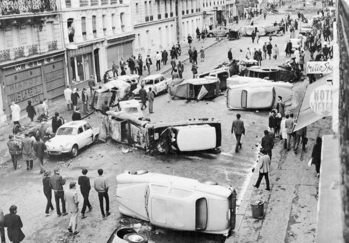 Barricades made of overturned cars block Gay Lussac Street in Paris after rioting and demonstrations by students demanding sweeping reforms at the Sorbonne University.