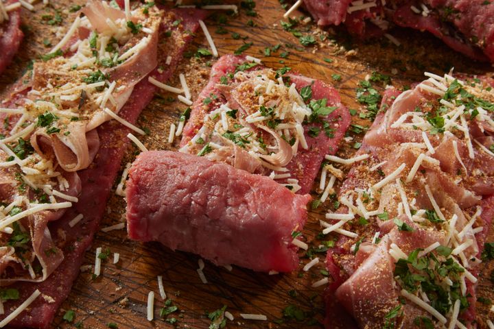 Preparing Beef Braciole ; Flattened Flank Steak Rolled up with Prosciutto, Herbs, Garlic and Parmesan Cheese