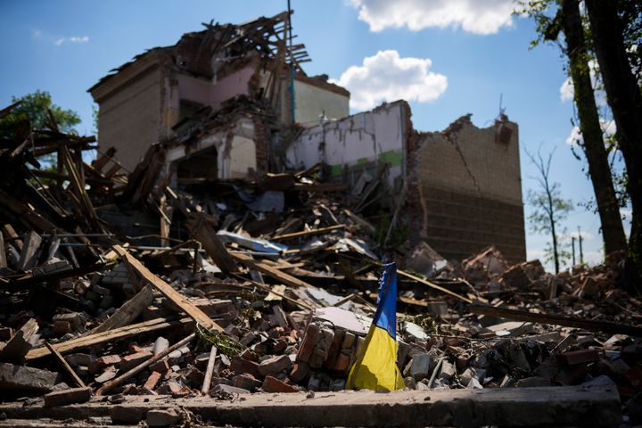 A torn Ukraine flag waves among debris in a school destroyed in a Russian bombing in Bakhmut, eastern Ukraine, on May 24, 2022. The town of Bakhmut has been coming under increasing artillery strikes, particularly over the last week, as Russian forces try to press forward to encircle the city of Sieverodonetsk.
