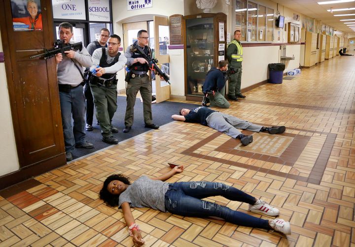 Law enforcement, first responders and students participate in a regional active shooter training at Deering High School in Portland, Maine.
