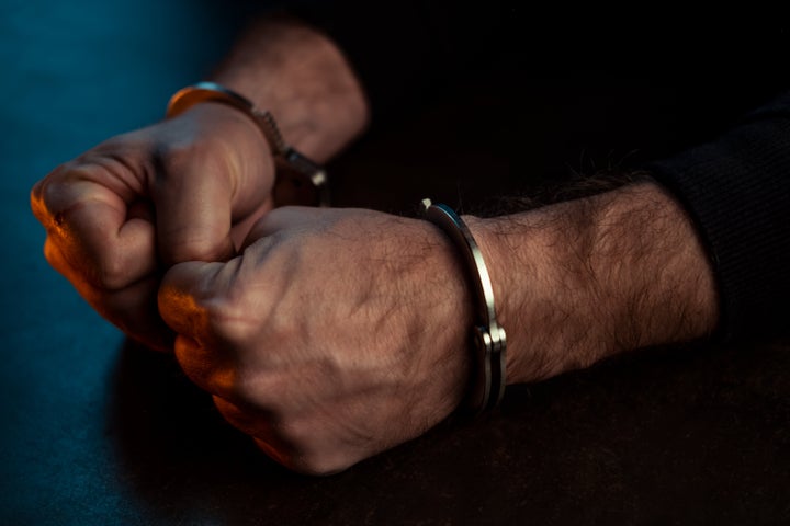 Close up of male hands in handcuffs