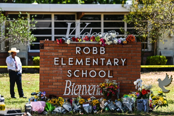 Flowers are placed on a makeshift memorial in front of Robb Elementary School in Uvalde, Texas, on May 25.