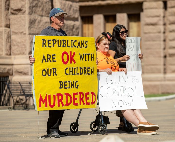 People hold signs during a protest at the Capitol in Austin, Texas, on May 25, 2022, after a mass shooting at an elementary school in Uvalde.