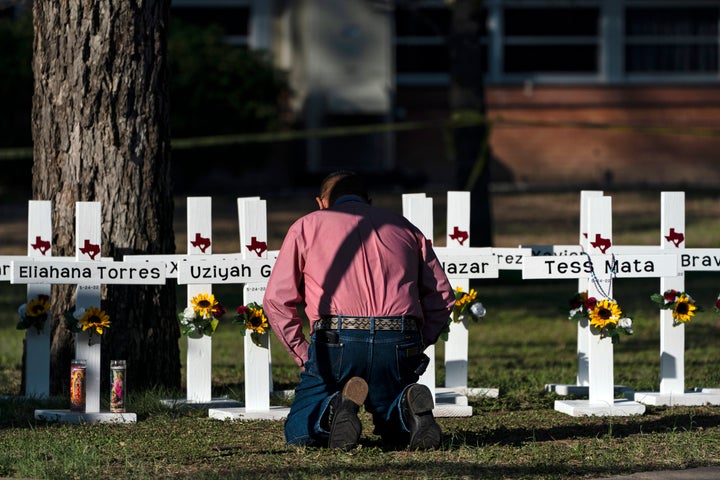Reverend Daniel Myers knelt in front of crosses bearing the names of the victims of the shooting on Tuesday and prayed for them at Robbie Elementary School in Uvalde, Texas.