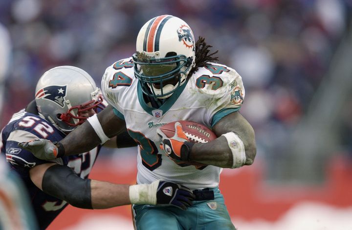 Ricky Williams carries the ball for the Miami Dolphins during the 2002 season in which he rushed for a career-high 1,853 yards.