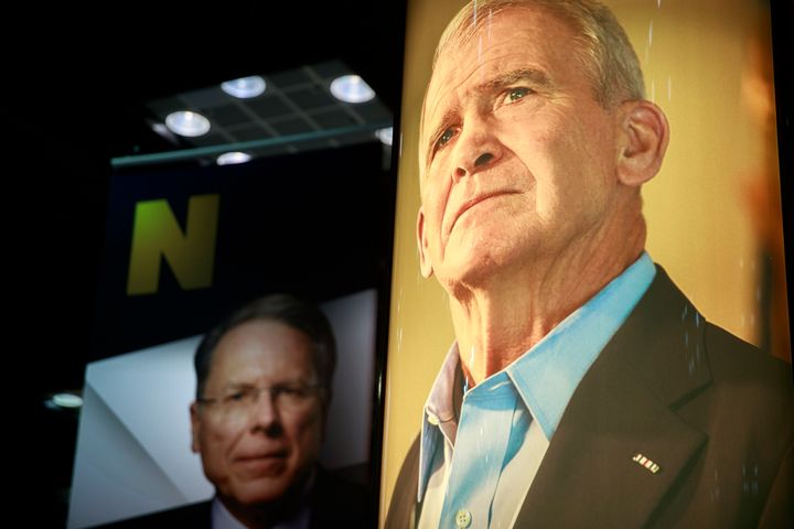 Photos of NRA CEO and Executive Vice President Wayne LaPierre (left) and former president of the NRA Oliver North (right) are on display during the third day of the National Rifle Association convention in 2019.