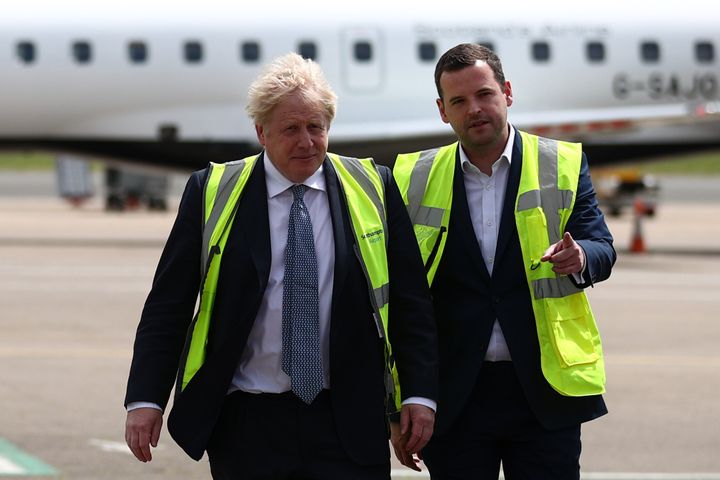Boris Johnson speaks with Conservative MP for Eastleigh Paul Holmes, on the tarmac of Southampton airport during a visit to the Eastleigh constituency.