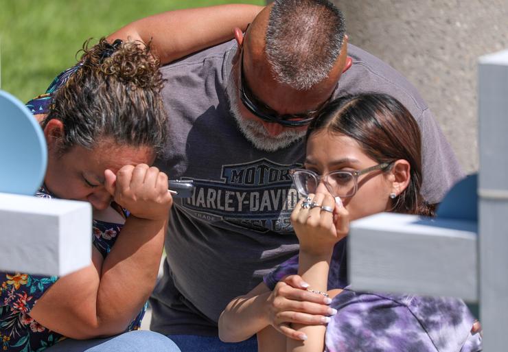 Mourners visit a memorial for victims of Tuesday's mass shooting at Robb Elementary School in Uvalde, Texas.