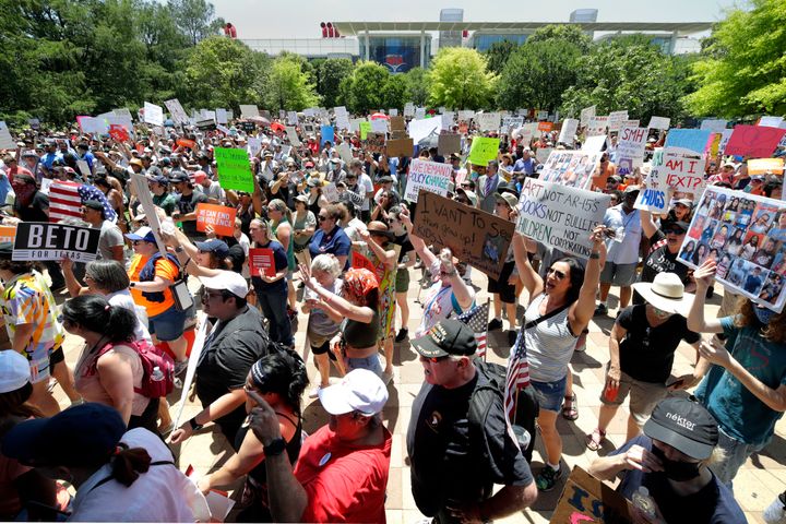Protesters hold a rally at Discovery Green Park, across the street from the National Rifle Association Annual Meeting held at the George R. Brown Convention Center Friday, May 27, 2022, in Houston. (AP Photo/Michael Wyke)