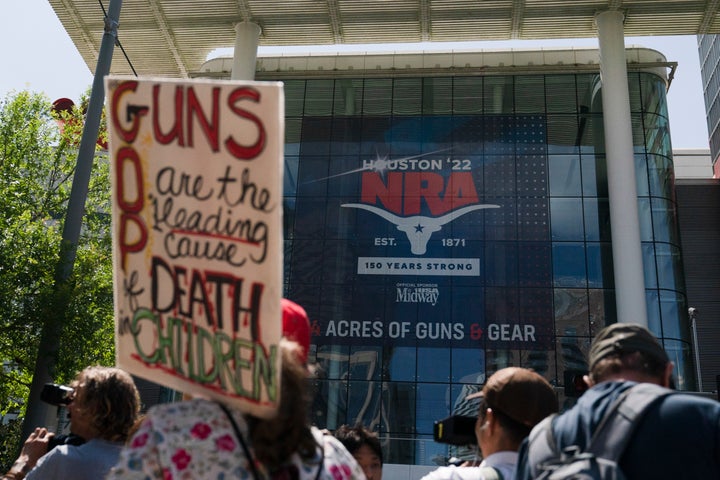 People gather outside the George R. Brown Convention Center to protest the National Rifle Association's annual meeting in Houston, Friday, May 27, 2022. (AP Photo/Jae C. Hong)