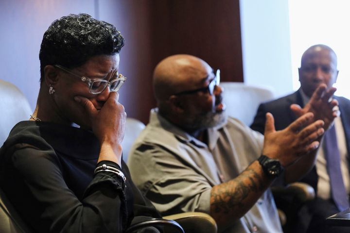 Veldarin Jackson, Sr., center, talks about receiving the call that his mother, Janice Reed, had died as his wife Adjoa Jackson, left, becomes emotional, Tuesday, May 24, 2022, in Chicago.