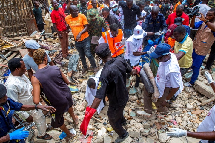 SENSITIVE MATERIAL. THIS IMAGE MAY OFFEND OR DISTURB Health and rescue workers carry the body of a woman from the collapsed building at the explosion site along Aba road in Sabon Gari, Kano, Nigeria May 17, 2022. REUTERS/Sani Maikatanga TPX IMAGES OF THE DAY