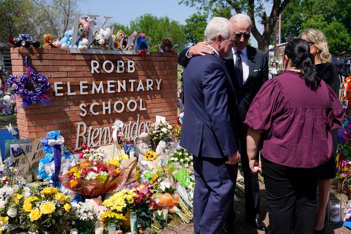 President Joe Biden and first lady Jill Biden talk with principal Mandy Gutierrez and superintendent Hal Harrell as they visit Robb Elementary School to pay their respects to the victims of the mass shooting, Sunday, May 29, 2022, in Ulvade, Texas. (AP Photo/Evan Vucci)