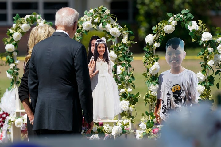 President Joe Biden and first lady Jill Biden visit a memorial at Robb Elementary School as they pay their respects to the victims of the mass shooting, Sunday, May 29, 2022, in Ulvade, Texas. (AP Photo/Evan Vucci)