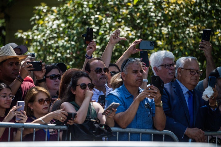 Fenced-off crowd boos and turns thumb down at Texas GOP Gov. Greg Abbott as he arrives while President Joe Biden and first lady Jill Biden to pay their respects at a makeshift memorial outside of Robb Elementary School in Uvalde.