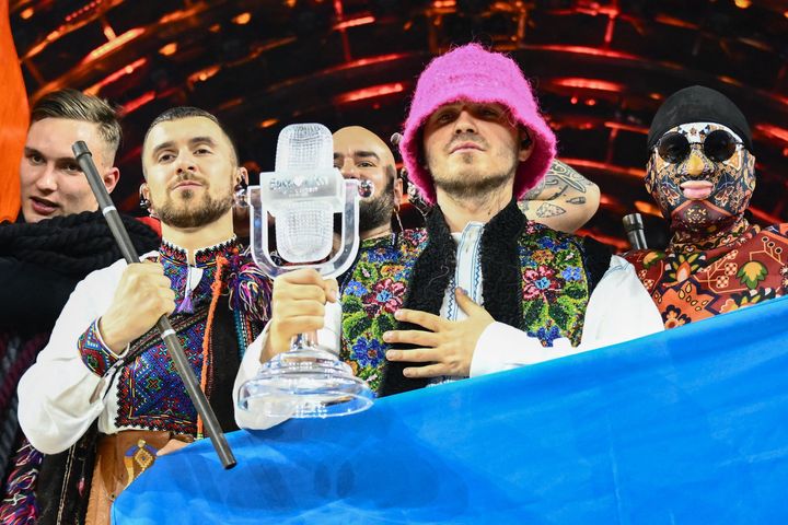 Kalush Orchestra pose onstage with the winner's trophy and Ukraine's flags after winning on behalf of Ukraine the Eurovision Song contest 2022 on May 14, 2022.