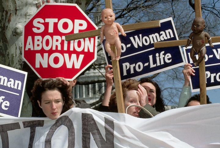 Anti-abortion demonstrators hold up signs during a demonstration commemorating the Roe versus Wade Supreme Court decision on abortion rights.