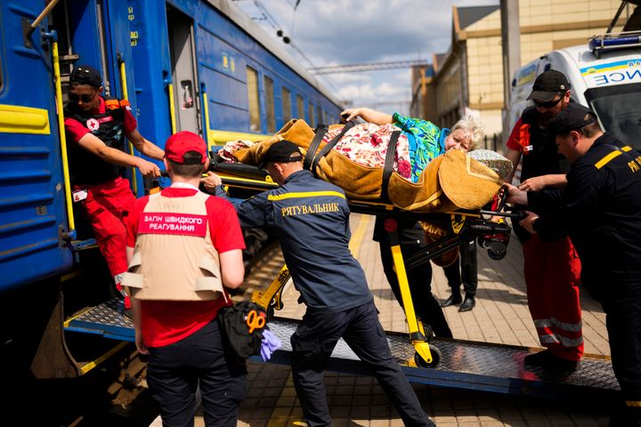 A patient is carried on a stretcher to board a medical evacuation train run by MSF (Doctors Without Borders) at the train station in Pokrovsk, eastern Ukraine, Sunday, May 29, 2022. The train is specially equipped and staffed with medical personnel, and ferries patients from overwhelmed hospitals near the front line, to medical facilities in western Ukraine, far from the fighting. 