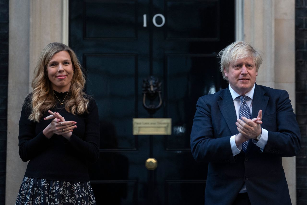 Boris Johnson and Carrie stand in Downing Street to clap for carers to recognise and support NHS workers and carers fighting the coronavirus pandemic. 