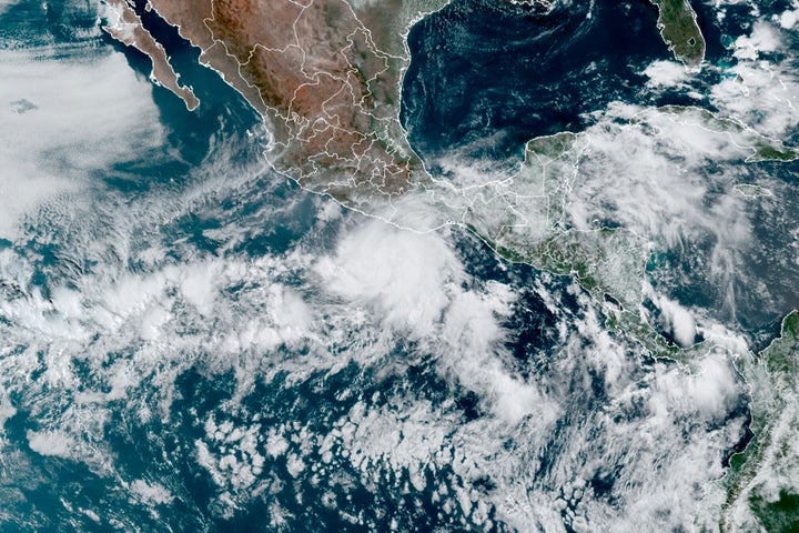 This satellite image made available by NOAA shows Hurricane Agatha, center, off the Pacific coast of Mexico on May 29, 2022, at 11:20 a.m. EDT.