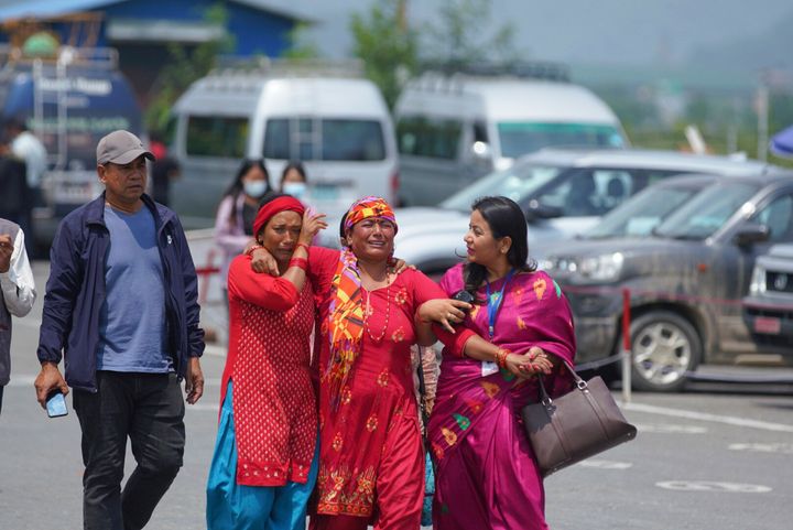 Relatives of passengers of the Tara Air turboprop Twin Otter plane that crashed gather outside the airport in Pokhara, Nepal, on May 30, 2022. 