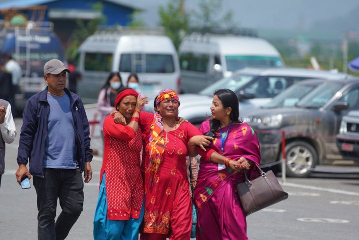 Relatives of passengers of the Tara Air turboprop Twin Otter plane that crashed gather outside the airport in Pokhara, Nepal, on May 30, 2022.