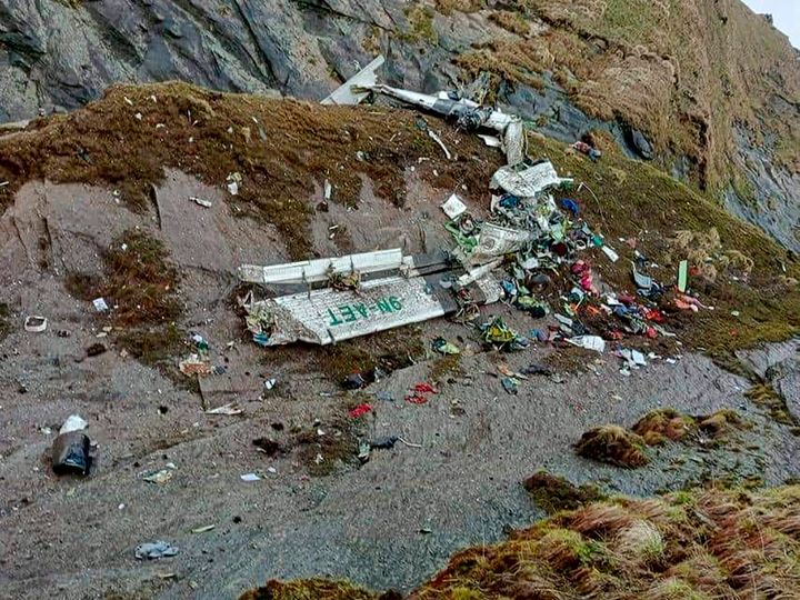 This handout photograph released by Fishtail Air shows the wreckage of a plane in a gorge in Sanosware in Mustang district close to the mountain town of Jomsom, west of Kathmandu, Nepal, on May 30, 2022. 