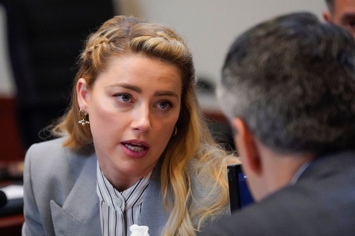 Actor Amber Heard speaks to her legal team as they arrive for closing arguments in the Depp v. Heard trial.