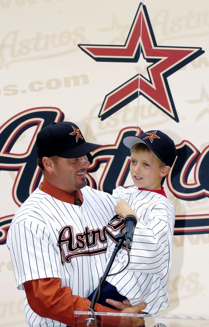 Roger Clemens holds his son, Kody (age 7), during a 2004 press conference. 