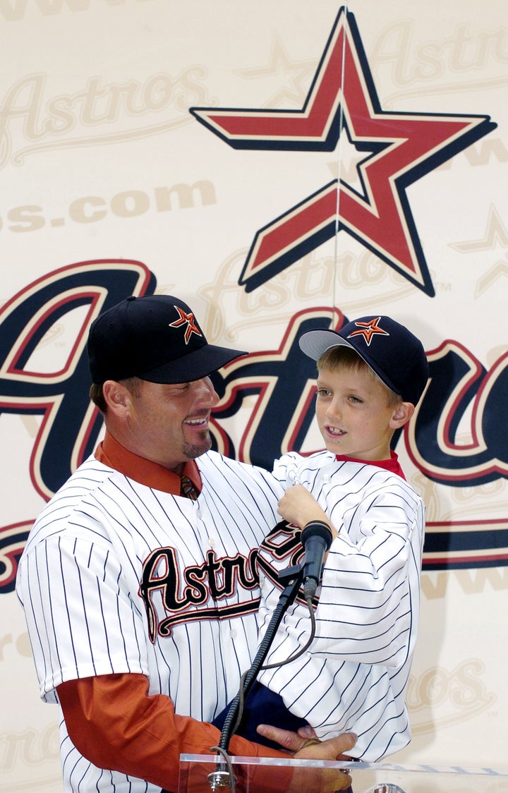 Roger Clemens holds his son, Kody (age 7), during a 2004 press conference.
