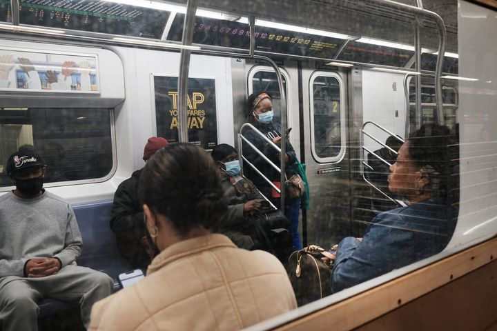 People ride the Brooklyn subway on April 13, a day after a man shot several people on a Manhattan-bound train in Brooklyn.