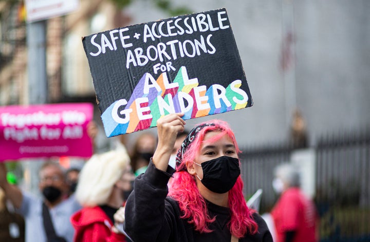 A protester highlights the need for trans-inclusive abortion service at an October 2021 gathering organized by NYC for Abortion rights outside St. Paul's Roman Catholic Church in New York City.