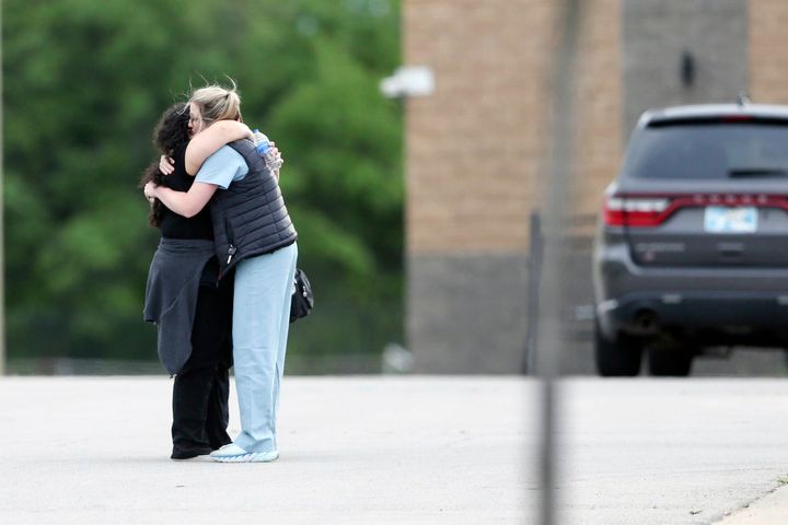 Two people hug as they are reunited at Memorial High School after being evacuated from the scene of a shooting at the Natalie Medical Building Wednesday, June 1, 2022. in Tulsa, Okla. Multiple people were shot at a Tulsa medical building on a hospital campus Wednesday.