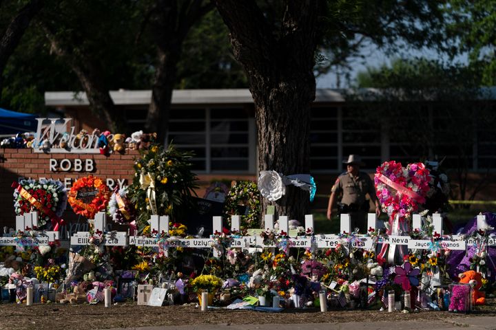 Flowers and candles are placed around crosses at a memorial outside Robb Elementary School to honor the victims killed in this week's school shooting in Uvalde, Texas Saturday, May 28, 2022. (AP Photo/Jae C. Hong, File)