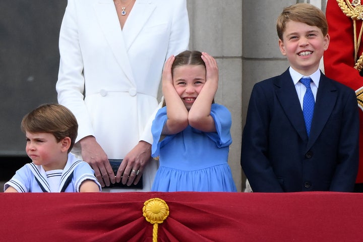 Charlotte's turn to cover her ears, while a very grown-up George grins! 