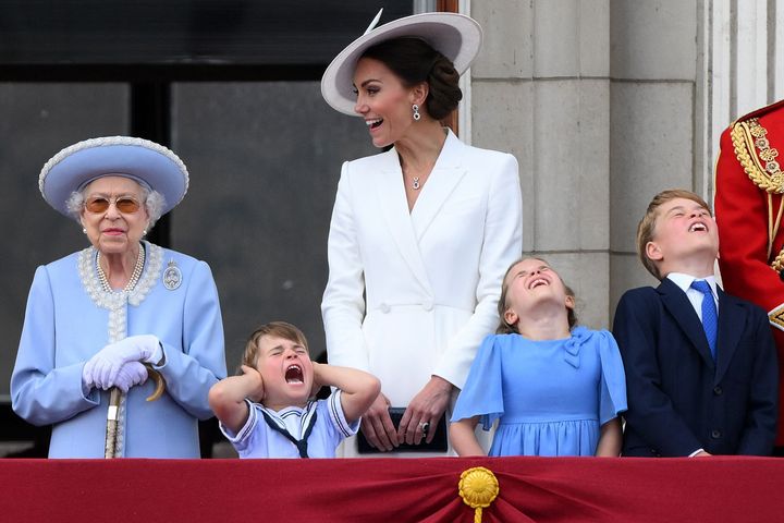Kate Middleton smiles and Queen Elizabeth grins as little Louis covers his ears during the Royal Air Force flypast over Buckingham Palace.