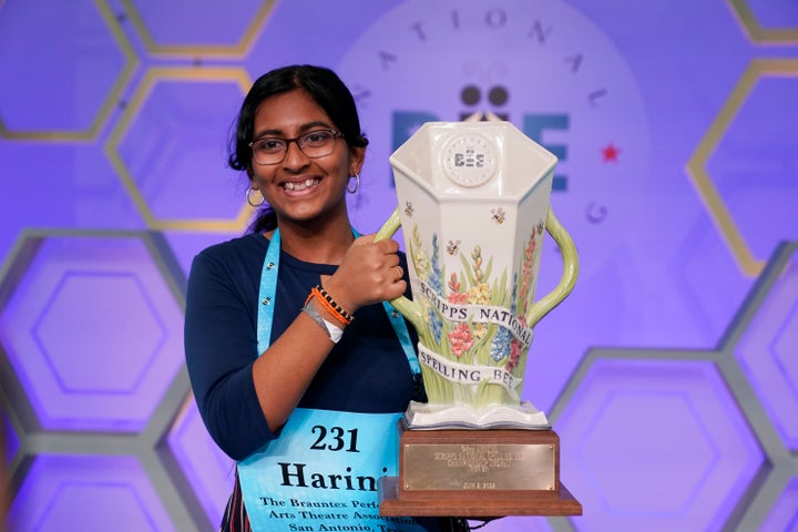 Harini Logan holds her winning Scripps National Spelling Bee trophy on Thursday.