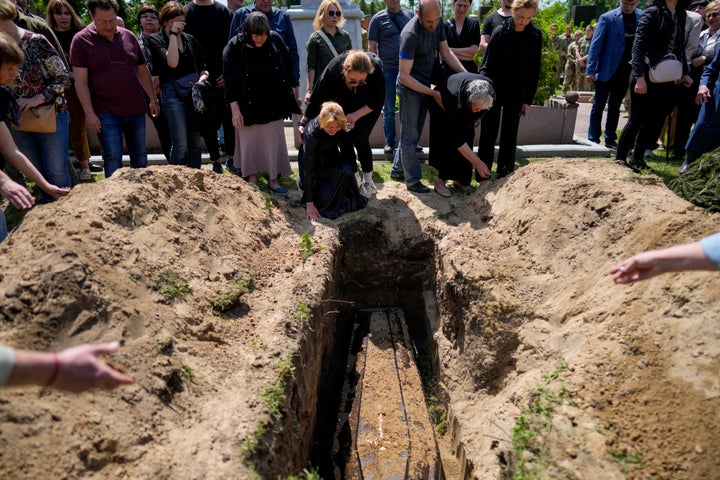 Relatives of Army Colonel Alexander Makhachek mourn his funeral in Zhytomyr, Ukraine on Friday, June 3, 2022.