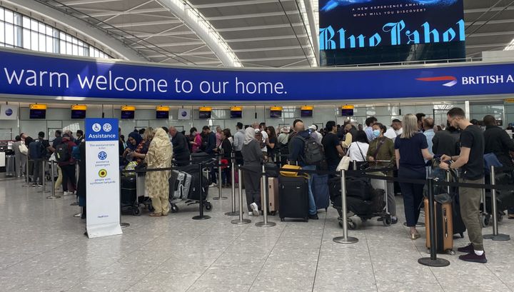 Passengers queue to check-in for a Qatar Airways flight in Terminal 5 at Heathrow Airport.