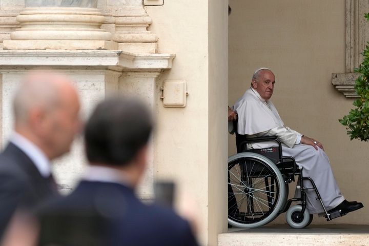 Pope Francis arrives on a wheelchair for an audience with children in the San Damaso courtyard at the Vatican, Saturday, June 4, 2022. (AP Photo/Alessandra Tarantino, File)