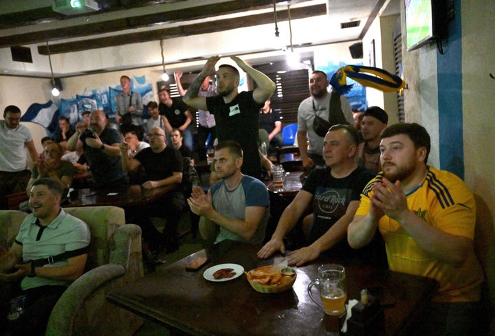 Ukrainian supporters react as they watch the FIFA World Cup 2022 play-off final qualifier football match between Wales and Ukraine in a pub in Kyiv, on June 5, 2022.